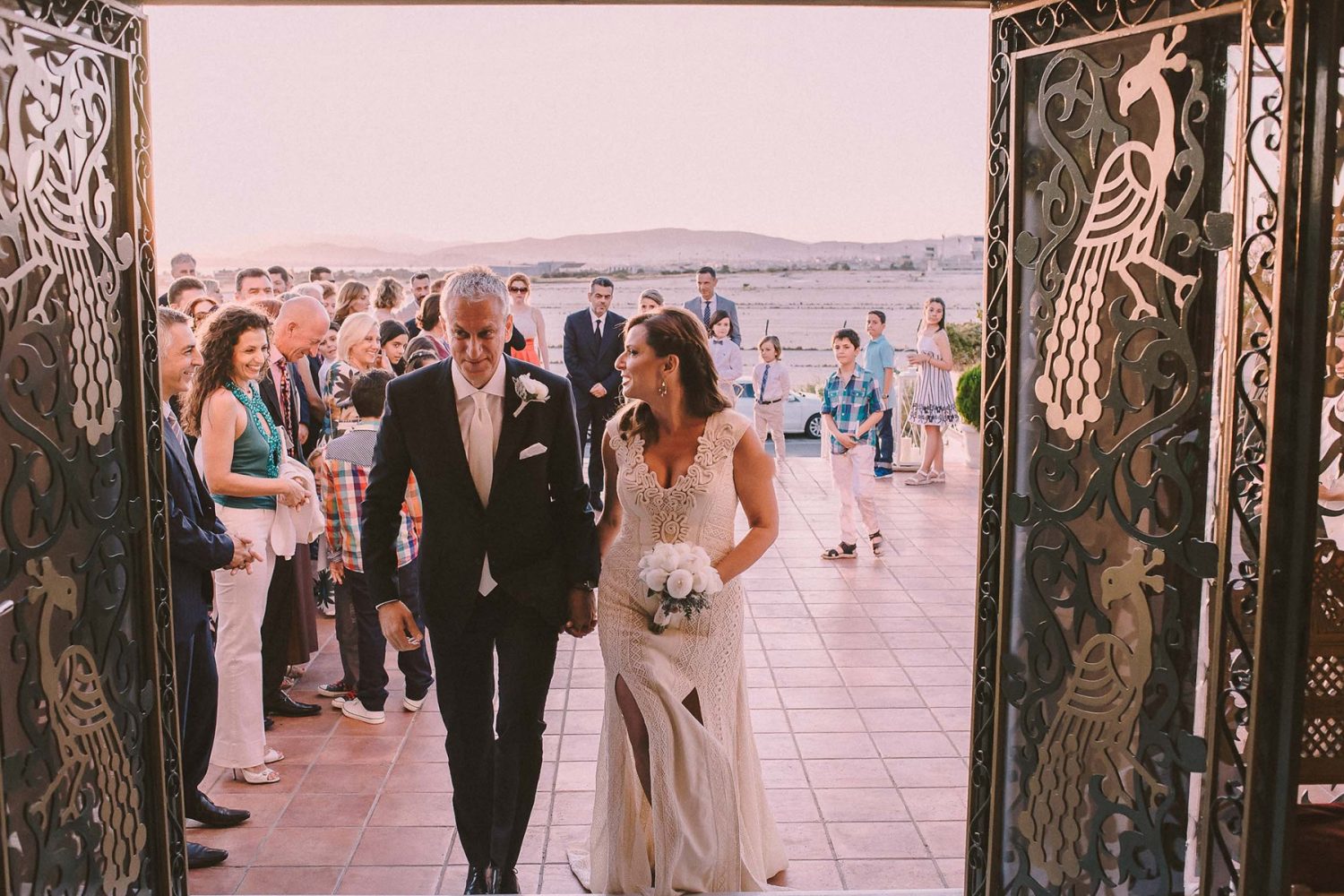 Bride and groom entering the church during their wedding in Glyfada