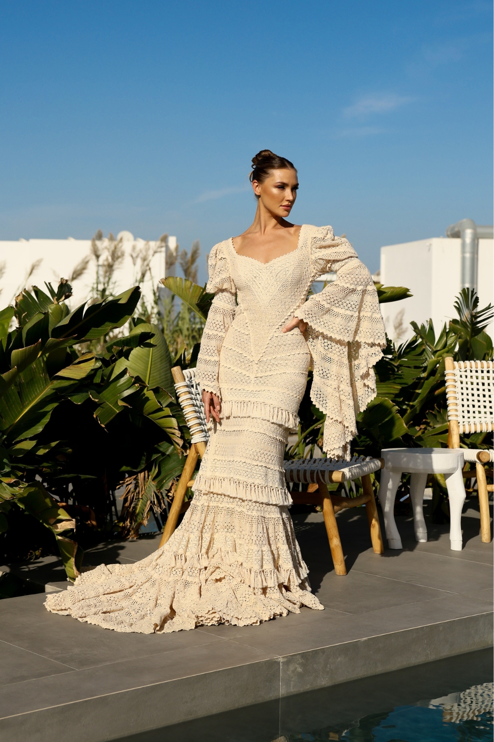 venetsanos-winery-wedding-dress-zolotas-atelier (9) Bride posing in Santorini, in a long sleeve mermaid wedding dress with long bridal train